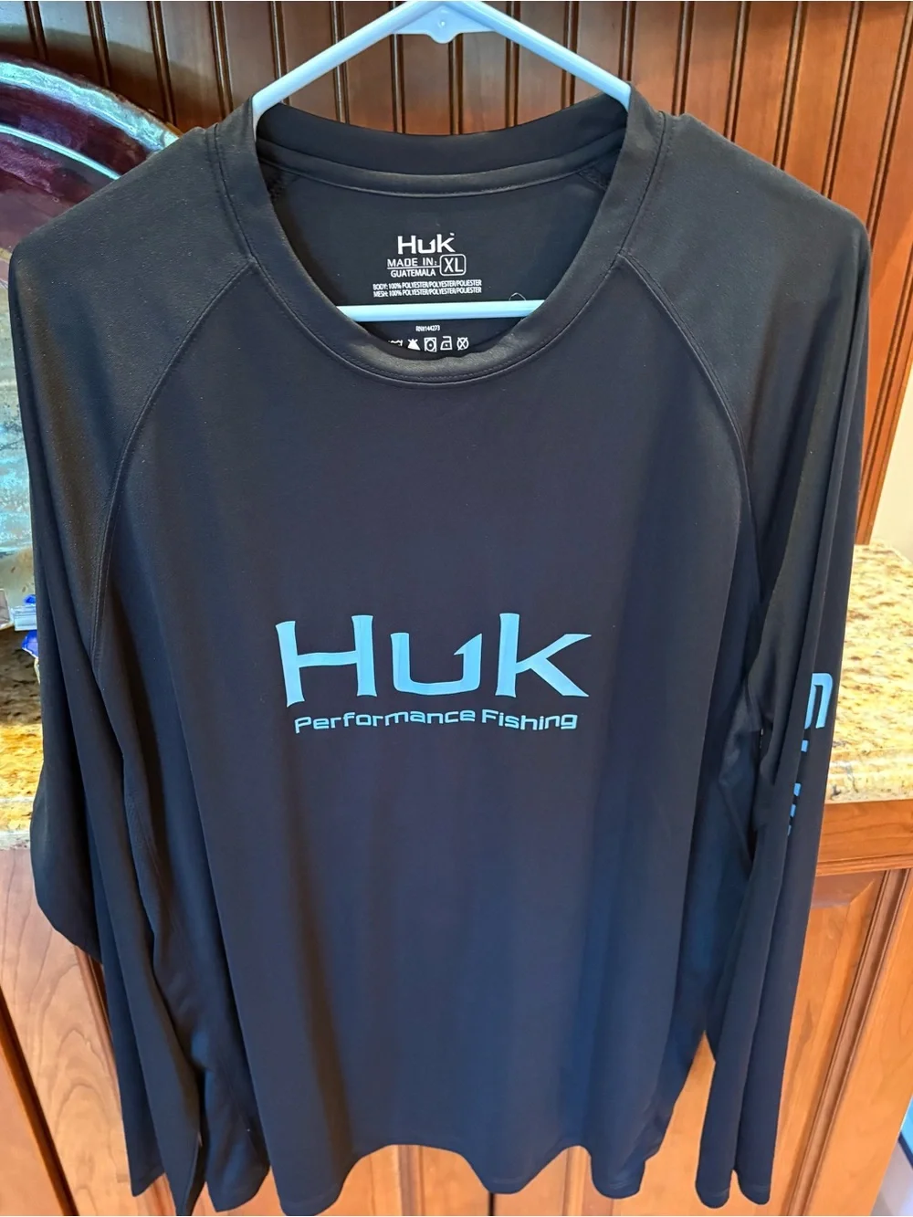 Huk men’s long sleeve performance Fishing Shirt. Sharp Black with blue logos.